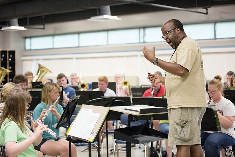 Brantley Douglas directs a piece Monday night at a rehearsal of the Conway Community Band, made up of musicians from central Arkansas. The group will perform its Fourth of July program at 7:30 p.m. today in Simon Park on Front Street in downtown Conway. The 106th Army Band Five Star Brass Quintet will make a special appearance.