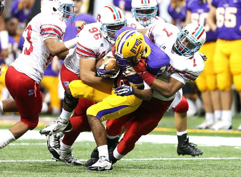 Rummel defenders Briston Guidry (96) and Dwayne Eugene (7) bring down Byrd wide receiver Tysen Hardman (3) for a loss in the third quarter during the Division I state football championship game between Byrd and Archbishop Rummel on Thursday, December 12, 2013. (Michael DeMocker, Nola.com / The Times-Picayune)