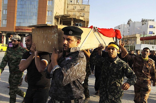 Mourners carry the flag-draped coffin of Iraqi soldier Zidane Ahmed, 29, during his funeral procession Thursday in the Shiite holy city of Najaf. Zidane’s body was found blindfolded and shot several times in Mosul, his family said.