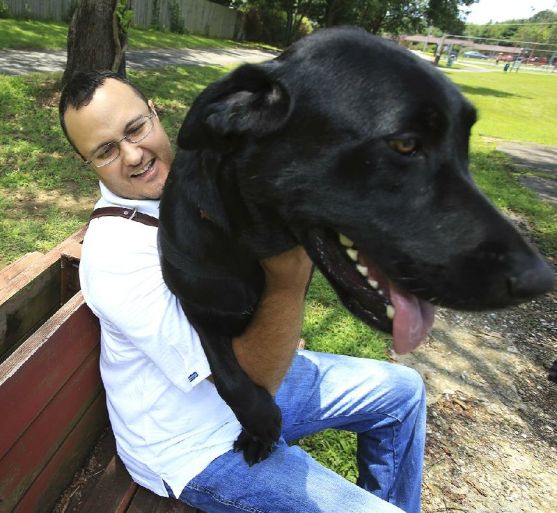 Rocky, a Labrador retriever, enjoys a day at the park Wednesday with James Blanford of Searcy. The dog is trained to help Blanford cope with post-traumatic stress disorder.