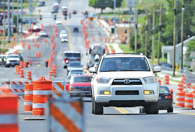 STAFF PHOTO ANDY SHUPE Traffic flows Wednesday on Garland Avenue in Fayetteville past rows of cones as construction continues to widen the roadway. Work is expected to be completed by fall. The roughly $5.2 million project is being paid for through the city&#8217;s $65.9 million Transportation Improvement Bond Program voters approved in 2006.