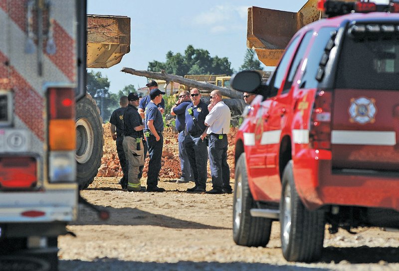 STAFF PHOTO BEN GOFF &#8226; @NWABenGoff Rogers authorities investigate a death Friday at a construction site on West JB Hunt Drive in the Pinnacle Hills area of Rogers.