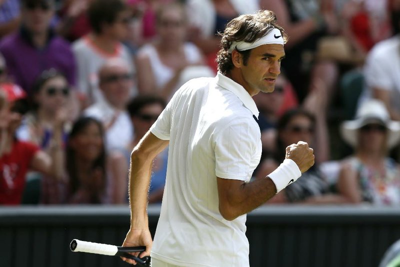 Roger Federer of Switzerland celebrates a point against Milos Raonic of Canada during their men's singles semifinal match at the All England Lawn Tennis Championships in Wimbledon, London, Friday, July 4, 2014. (AP Photo/Ben Curtis)