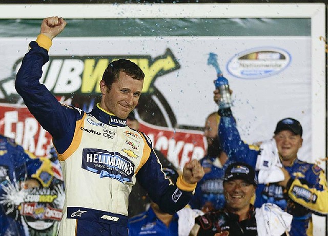 Kasey Kahne celebrates in Victory Lane after winning the NASCAR Nationwide series auto race at Daytona International Speedway in Daytona Beach, Fla., Friday, July 4, 2014. (AP Photo/John Raoux)