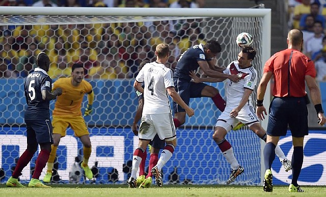 Germany's Mats Hummels, second right,  scores the opening goal during the World Cup quarterfinal soccer match between Germany and France at the Maracana Stadium in Rio de Janeiro, Brazil, Friday, July 4, 2014. (AP Photo/Martin Meissner)