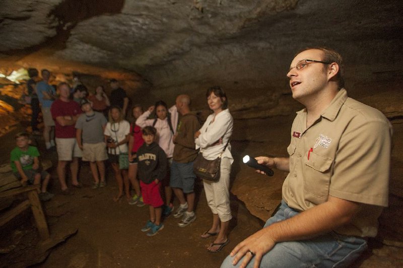 RYAN MCGEENEY/Arkansas Democrat-Gazette --07-02-2014-- 
Tony Hebaugh[cqrm], a cave guide with War Eagle Cavern, describes the geology near the entrance of the cavern for a tour group Wednesday morning. War Eagle is one of eight "show caves" open to the public through guided tours. Owners of some caves have voiced concern that the U.S. Forest Service's recent decision to extend the closure of caves on Forest Service land through 2019 will have a negative economic impact on their attractions.