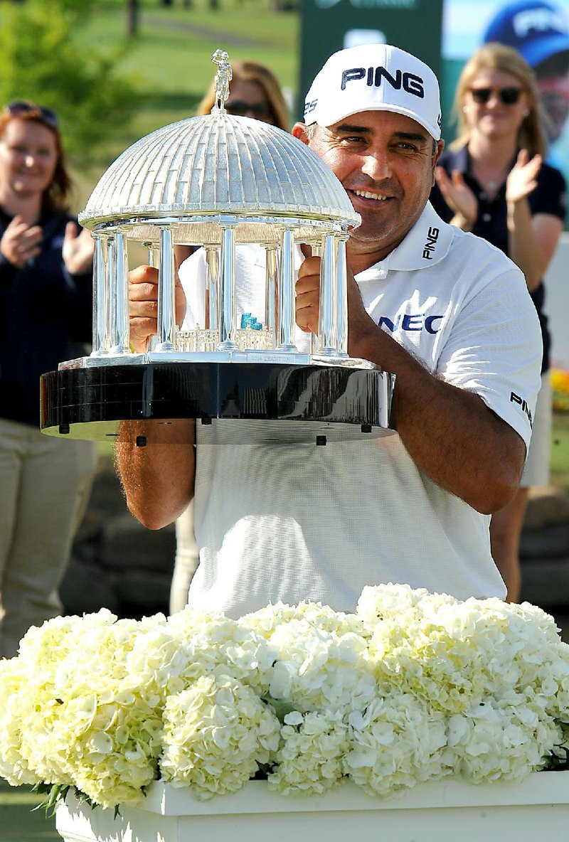 Angel Cabrera holds up The Greenbrier Classic Springhouse Trophy after winning the Greenbrier Classic golf tournament at the Greenbrier Resort in White Sulphur Springs, W.Va., Sunday, July 6, 2014.  (AP Photo/Chris Tilley)