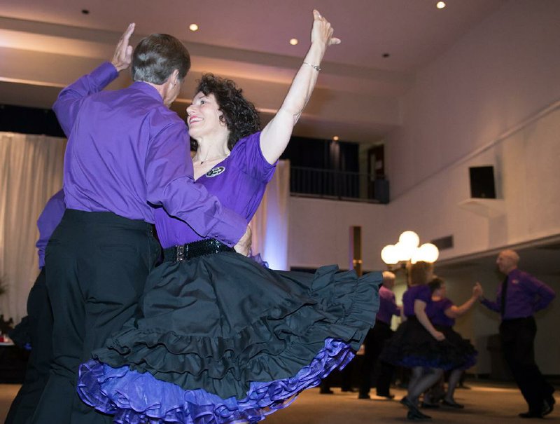 Special to the Democrat-Gazette/ANGIE DAVIS
Members of Razzle Dazzle, an exhibition square-dance team from St. Louis, perform June 28 during a fashion show hosted by the National Square Dance Convention at the Robinson Center Exhibition Hall in Little Rock.
