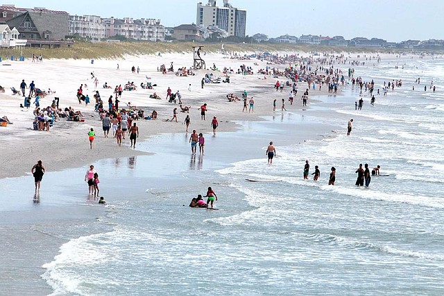 This photo shows beachgoers in Wrightsville Beach, N.C., Saturday July 5, 2014. (AP Photo/The Star-News, Jason A. Frizzelle)