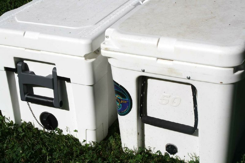 Major differences in the Igloo Sportsman 55 (left) and the Yeti Tundra 50 are the drain spout sizes, drain plug styles and handle styles. Both have textured lid tops, but Igloo’s is raised with metric and standard rulers for measuring fish. The Igloo also has true 55-quart capacity. The Yeti has a 45-quart box, despite its name.