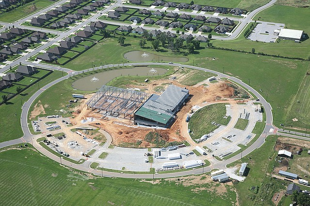 Courtesy Photo This aerial photo shows Bentonville&#8217;s Community Recreation Center under construction in the middle of a circular road attached to parking lots completed a couple of years ago in phase one of the project. Work on the roof started on the south side over the gymnasium and is working its way north over the multipurpose rooms.