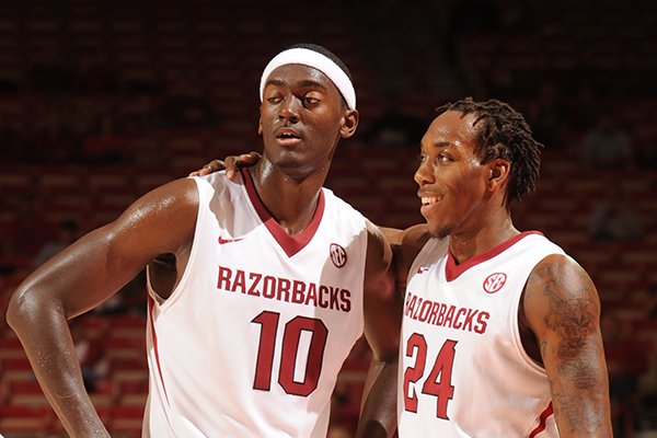 Arkansas freshman forward Bobby Portis, left, shares a laugh with sophomore guard Michael Qualls during the second half of play against Northeastern State Tuesday, Nov. 5, 2013, in Bud Walton Arena in Fayetteville.