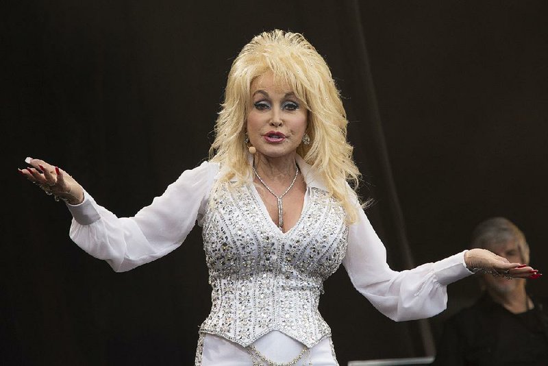 Dolly Parton performs on the main Pyramid stage at Glastonbury music festival, England, Sunday, June 29, 2014.  Thousands of music fans have arrived for the festival to see headliners Arcade Fire, Metallica and Kasabian. (Photo by Joel Ryan/Invision/AP)