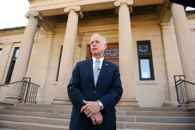 U.S. Sen. Ron Johnson holds a news conference on the steps of Wisconsin Eastern District Federal Courthouse Monday, July 7, 2014 in Green Bay, Wis. A government attorney is trying to persuade a federal judge in Green Bay to toss out Johnson's lawsuit challenging rules forcing congressional members and their employees to seek government-subsidized health insurance through small business exchanges. U.S. Justice Department attorney James Luh  told U.S. District Judge William Griesbach on Monday that Johnson can't sue because he hasn't shown how the rules have caused him any injury. (AP Photo/The Green Bay Press-Gazette, Jim Matthews)  NO SALES