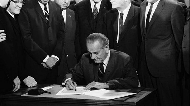 President Lyndon Johnson signs the landmark Civil Rights Act of 1964 into law on July 2, 1964.