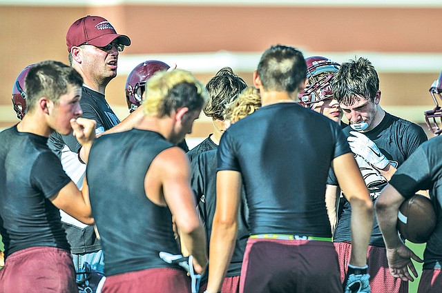 STAFF PHOTO ANTHONY REYES Scott Davenport, Lincoln head football coach, talks to his team Monday during a 7-on-7 scrimmage at Springdale Har-Ber.