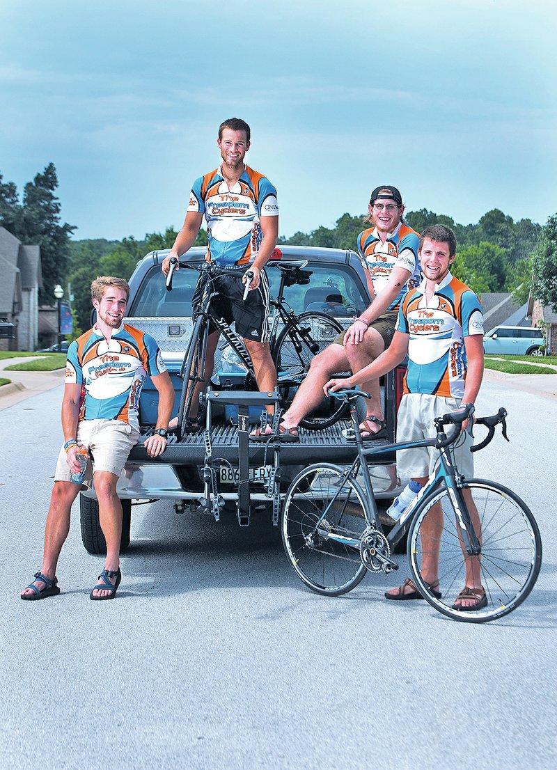 STAFF PHOTO SAMANTHA BAKER &#8226; @NWASAMANTHA Jason Elliott, from left, Jeff Maier, Taylor Carlisle and Matthew Roelofs, seniors at the University of Tennessee, pose with their bicycles Monday in Rogers after cycling into town on their way across the United States. The Freedom Cyclers, as they call themselves, are cycling across the country to raise awareness and money in an effort to end human trafficking. The team began its trip near Los Angeles on June 11 and plan to end in Savannah, Ga. on July 25.
