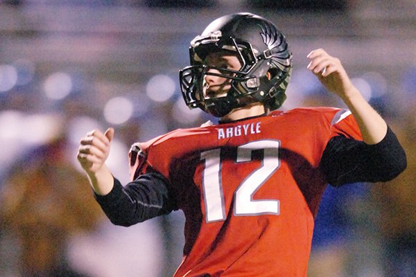 Argyle senior kicker Cole Hedlund (12) watches an extra point kick go through the uprights against Krum in a Class 3A Division 2 Region 2 Bidistrict playoff game, Thursday, Nov. 14, 2013, at C.H. Collins Athletic Complex in Denton, Texas.