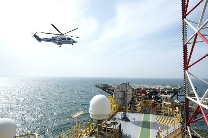 A helicopter nears the helipad on an offshore natural gas rig last year in the Odessa gas field in the Black Sea off the coast of Ukraine. Several nations are rejecting the European Union’s attempt to pressure Russia over its invasion of the Crimean Peninsula by curtailing work on a natural gas pipeline.