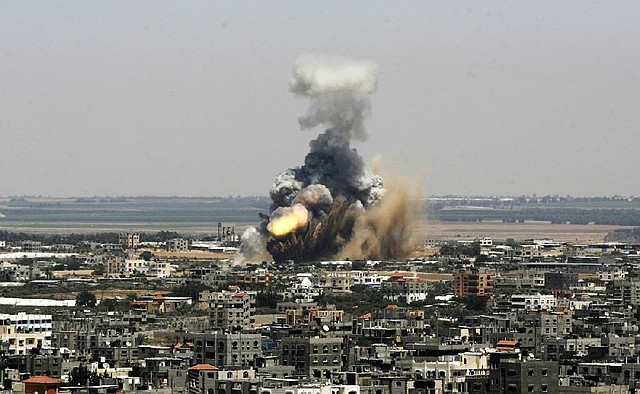 An Israeli missile explodes on impact Tuesday in Rafah, southern Gaza Strip. The Israeli military launched what could be a long-term offensive, hitting more than 150 sites and mobilizing troops for a possible ground invasion aimed at stopping rocket attacks against Israel.