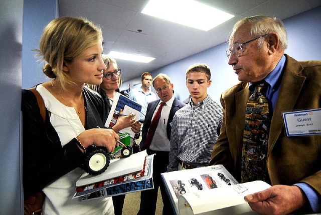 KC Walker (left), with the Electus film production company in California, talks with Joseph Ertl, president of Dyersville Die Cast of Iowa at Wal-Mart’s supplier event Tuesday in Bentonville.