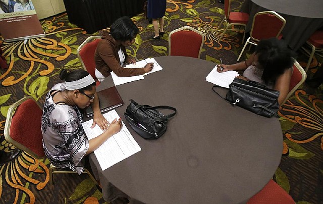 Job seekers complete applications at the Cleveland Career Fair last month in Independence, Ohio. The number of job openings rose in May to the highest level in almost seven years.