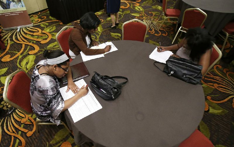 Job seekers complete applications at the Cleveland Career Fair last month in Independence, Ohio. The number of job openings rose in May to the highest level in almost seven years.