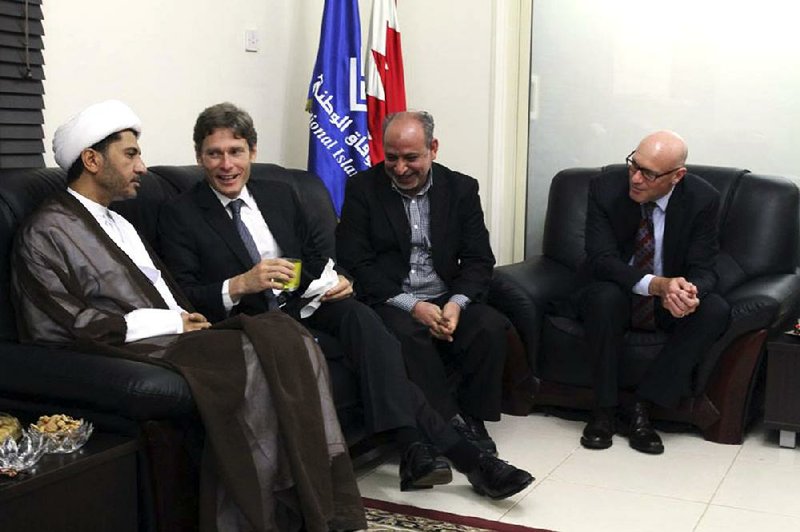 U.S. Assistant Secretary of State for Democracy, Human Rights and Labor Tom Malinowski (second from left) visits with Sheikh Ali Salman (left), head of the Wefaq National Islamic Society; former member of the Bahraini parliament Abdul Jalil Khalil (second from right); Timothy Pounds, deputy chief of mission at the U.S. Embassy in Bahrain; and others at a traditional weekly Ramadan gathering in Manama, Bahrain, in this photo taken Sunday and released by the Bahraini opposition group Al Wefaq.