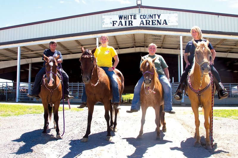 From left, Cookie Jackson, Brooklyn Duncan, Jeri Augustine and Beverly Duncan sit on, from left, Peanut, Ruby Ann, Sierra and Edie, in preparation for the White County Sheriff’s Mounted Patrol horse show.
