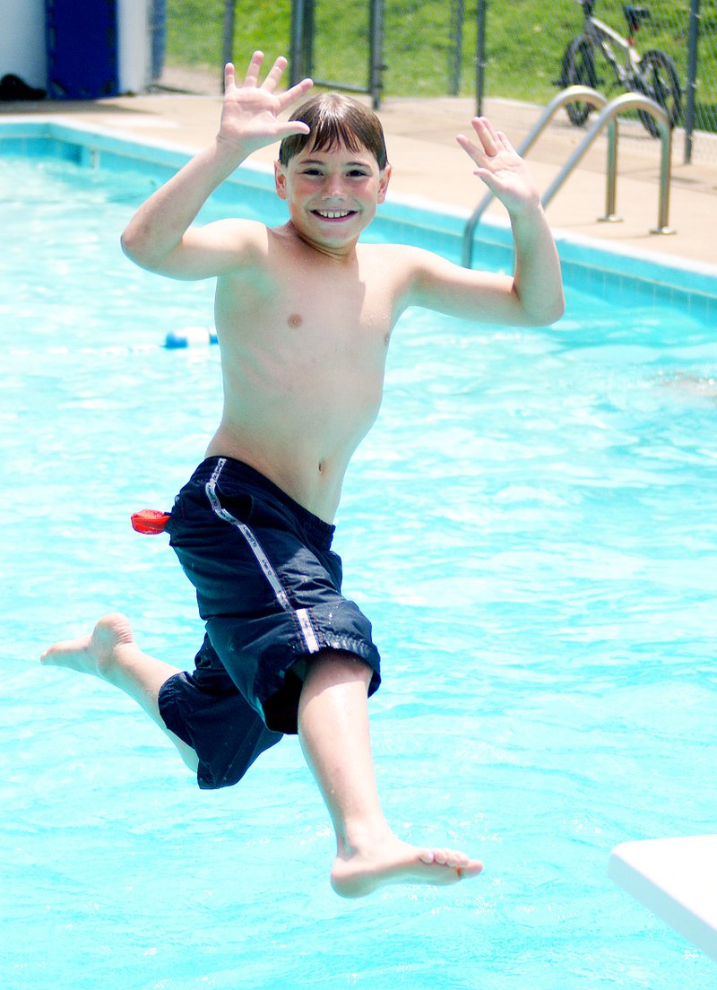 Photo by Randy Moll Riley Fenner, 10, jumps off the board and turns mid-air to pose for the camera at Decatur&#8217;s municipal pool on July 2. The municipal pool in Decatur is open from 1 to 5 p.m. Tuesday through Saturday.