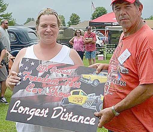 Heather Smith was presented the award for Longest distance traveled by Alan Ash, car show organizer.