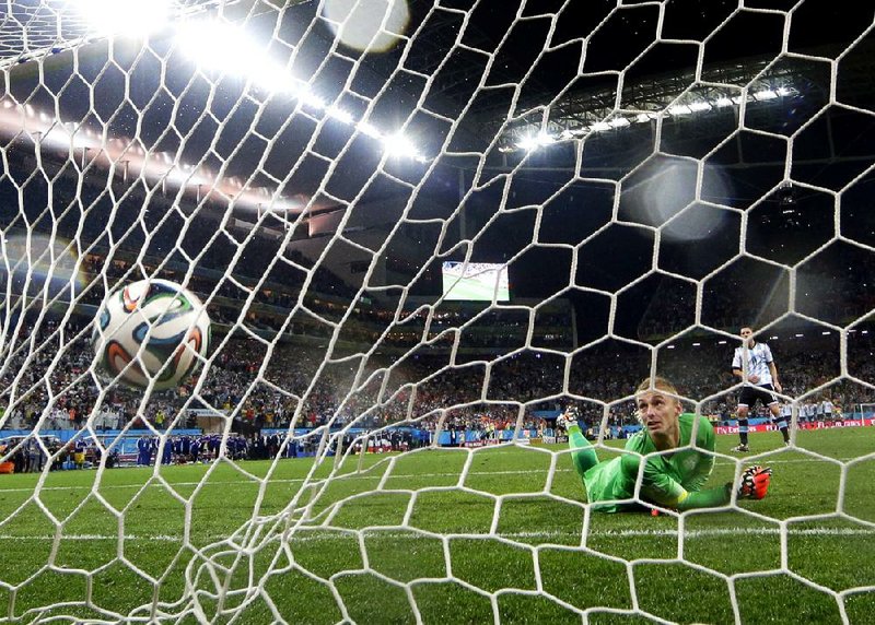 Netherlands goalkeeper Jasper Cillesseen watches the shot from Argentina’s Maxi Rodriguez hit the back of the net Wednesday, giving Argentina a 4-2 penalty-kick victory after a scoreless tie in a semifinal match in Sao Paulo.
