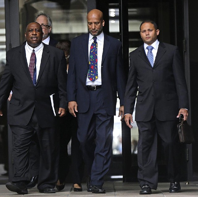 Former New Orleans Mayor Ray Nagin (center) leaves federal court after being sentenced Wednesday in New Orleans. Nagin was sentenced to 10 years in prison for bribery, money laundering and other corruption that spanned his two terms as mayor.
