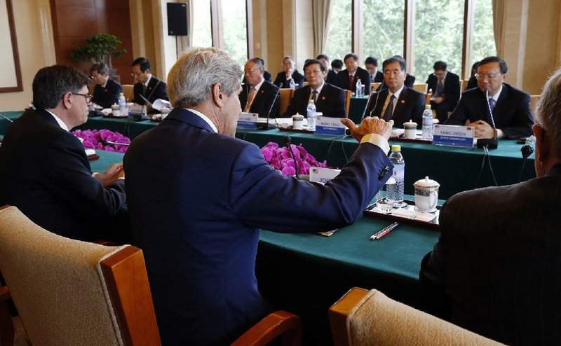 U.S. Secretary of State John Kerry (center) and Treasury Secretary Jack Lew (left) discuss climate change and clean energy with Chinese government officials Wednesday at the Diaoyutai State Guesthouse in Beijing.