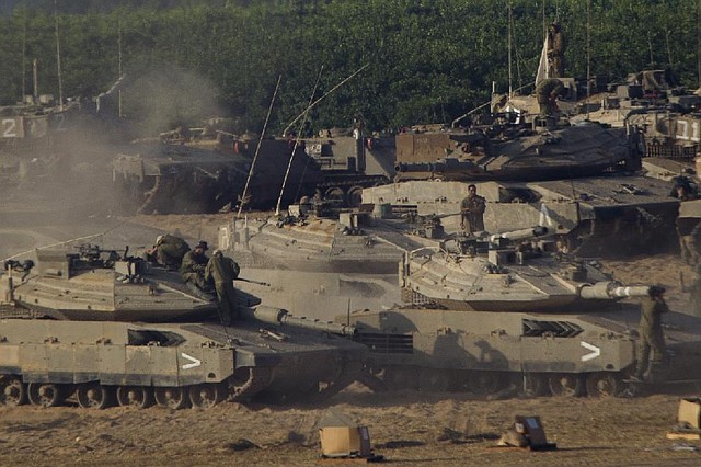 Israeli tanks sit at a staging area Wednesday near the Israel-Gaza border.
