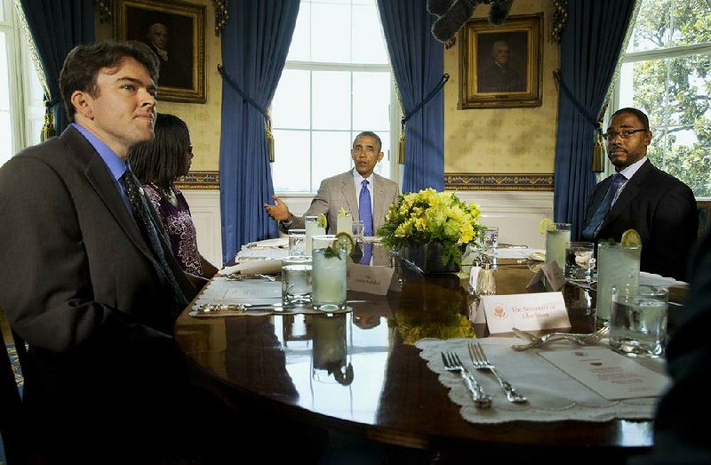 President Barack Obama (right) talks about education during a lunch meeting Monday in the White House with teachers, including Justin Minkel (left) of Springdale.