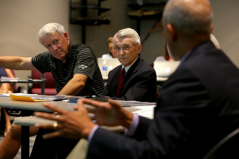Little Rock Technology Park Authority Board members Tom Butler (from left), Dickson Flake and C.J. Duvall discuss a proposed tech park site in downtown Little Rock at a meeting Wednesday.

