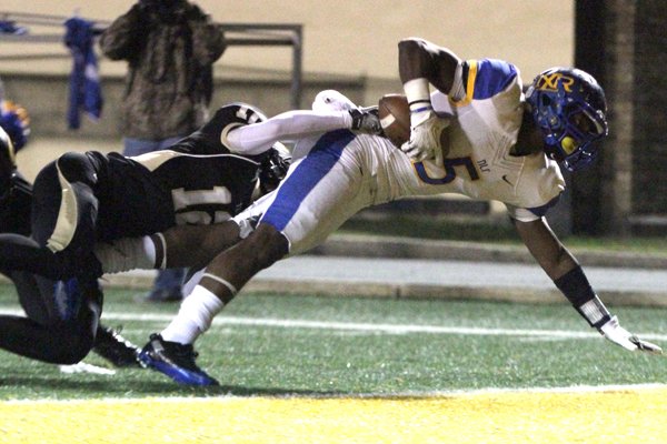 North Little Rock's KJ Hill scores a touchdown as Little Rock Central's Nick Hayes defends during their game Thursday night at Quigley Stadium.