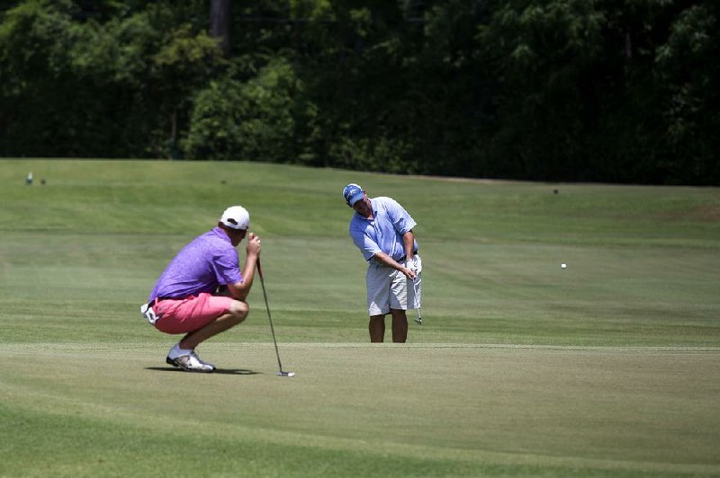 Staff photo by Curt Youngblood
Wes McNulty chips onto the 11th green during the Arkansas State Golf Association's Stroke Play Championship at Texarkana Country Club on Thursday. McNulty is the defending champion of the event and is attempting to win a third consecutive title.