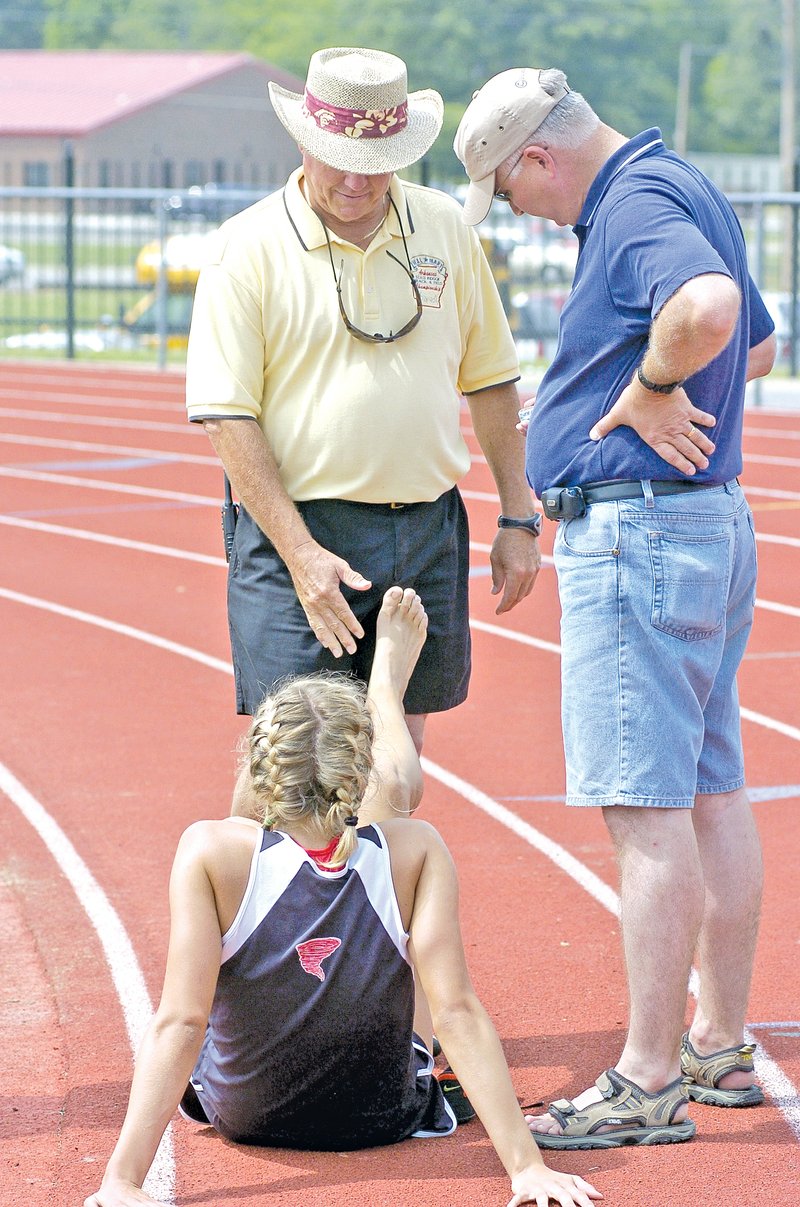 FILE PHOTO Arkansas Democrat-Gazette Don Carnahan, former Russellville track and cross country coach, checks on Lady Cyclones athlete Whitney Anderson at the 2004 state decathlon in Cabot. Carnahan, a Prairie Grove native, will be inducted into the Arkansas High School Coaches Association Hall of Fame today.