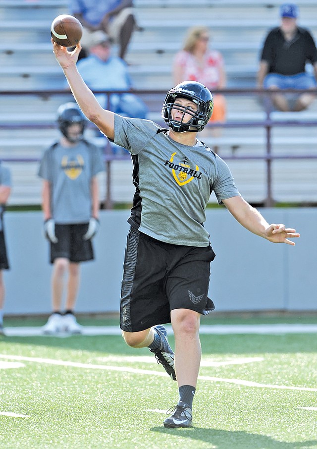  STAFF PHOTO ANDY SHUPE Dylan Soehner, Prairie Grove quarterback, makes a pass attempt while playing 7-on-7 Monday at Jarrell Williams Bulldog Stadium in Springdale.