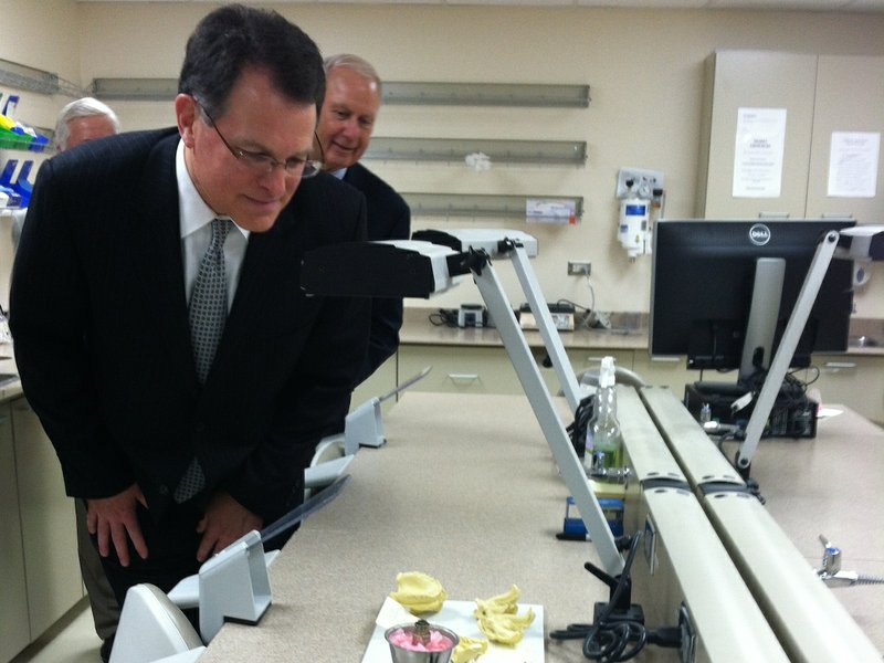 Ed Choate, president and CEO of Delta Dental, examines part of the new Delta Dental of Arkansas Foundation Oral Health Clinic at the University of Arkansas for Medical Sciences on Friday. 