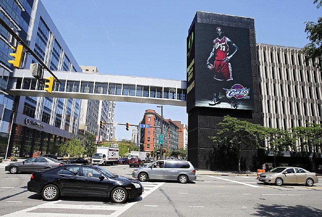 An electronic billboard in Cleveland trumpets the return of Le-Bron James to the Cavaliers after four years and four trips to the NBA Finals with the Miami Heat.