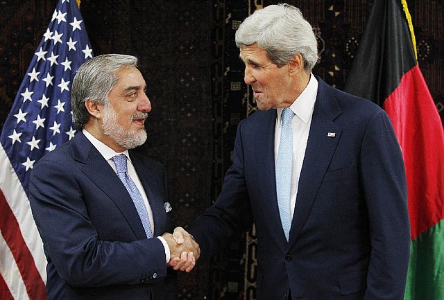 Afghan presidential candidate Abdullah Abdullah, left, shakes hands with U.S. Secretary of State John Kerry at the start of a meeting at the U.S. Embassy in Kabul, Friday, July 11, 2014. Kerry sought Friday to broker a deal between Afghanistan's rival presidential candidates as a bitter dispute over last month's runoff election risked spiraling out of control. (AP Photo/Jim Bourg, Pool)