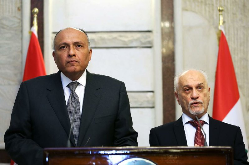 Hussain al-Shahristani, (right) Iraq’s energy minister, attends a news conference Friday with Egyptian Foreign Minister Sameh Shoukry in Baghdad. Al-Shahristani was appointed to replace a Kurd as interim foreign minister.