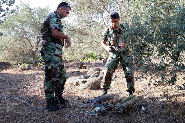 Lebanese army experts in the southern Lebanese village of Al-Mari dismantle two rockets that were discovered ready to be fired into northern Israel.