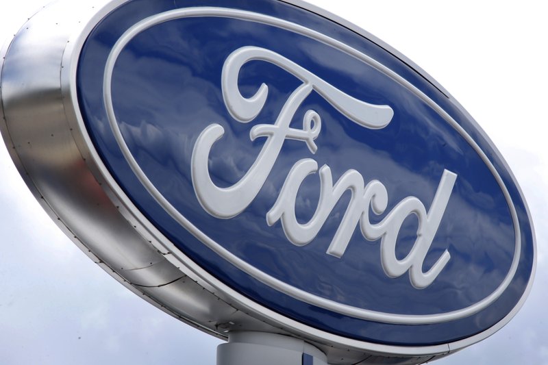 In this photo made on Thursday, June 5, 2014, clouds are reflected in the Ford sign at a dealership in Wexford, Pa. The National Highway Traffic Safety Administration says it is investigating steering problems in about 500,000 Ford cars. The investigation covers 2004 to 2007 Crown Victoria, Grand Marquis and Marauder models. 