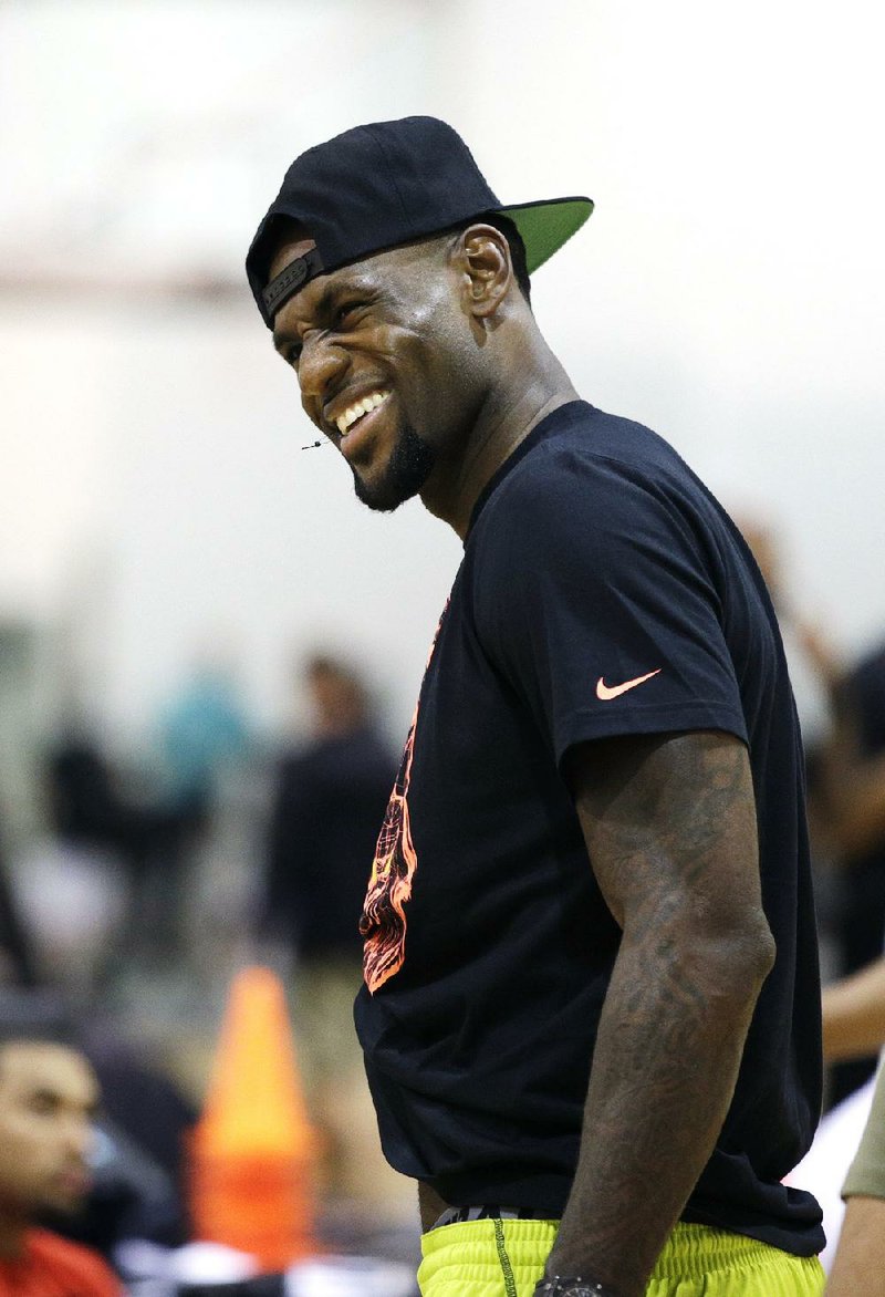 Lebron James smiles during the Lebron James Skills Academy Wednesday, July 9, 2014, in Las Vegas. Pat Riley made his pitch. And now, LeBron James wants time to think The Miami Heat president met with the four-time NBA MVP in Las Vegas, two people familiar with the situation told The Associated Press. James, his agent Rich Paul, Riley and Heat executive Andy Elisburg were at the meeting, said one of the people. (AP Photo/John Locher)