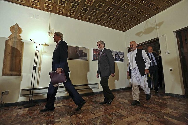 Secretary of State John Kerry arrives for a news conference Saturday in Kabul with Afghan presidential candidates Abdullah Abdullah (center) and Ashraf Ghani Ahmadzai.