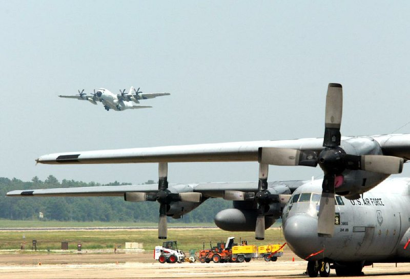 A C-130J flies over C-130H planes at Little Rock Air Force Base in Jacksonville in this file photo. A new Air Force Reserve unit, the 913th Airlift Group, will be activated at the base today and will add personnel and aircraft, possibly including 10 of the J-model aircraft.